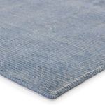 Close-up of low-profile dense weave and stitched edge in light blue and cream