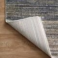 Rug corner flipped over revealing tightly woven cream and gray backing