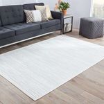 Rug laid flat in modern living room with dark gray sofa and hardwood floor
