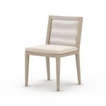 Three-quarter angled view focusing on chair’s rope backrest and cushion depth