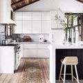 Narrow runner version of Layla Ocean Multi rug placed in white modern kitchen with wooden ceiling and bar stool