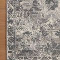 Close-up of rug corner on hardwood floor highlighting woven texture and tonal pattern detail