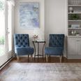 Loren Silver / Slate Rug shown in a living room with natural light, blue accent chairs, and side table