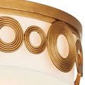 Close-up of multiple concentric brass ring patterns spaced evenly around light frame