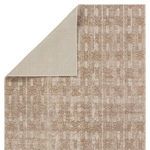 Backside corner folded to reveal beige solid underside with faint embossed geometric pattern