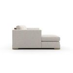 Side profile of left chaise sectional showing armrest height and chaise length with textured fabric