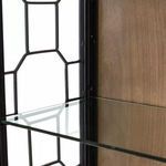 Detailed close-up of a tempered glass shelf inside cabinet showing thickness and metal frame support.