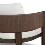 Close-up of woven cording wrapping around back of chair with white cushions underneath