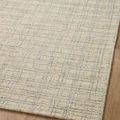 Angled close-up showing woven texture and faint grid detail on Polly Antique Mist rug surface.