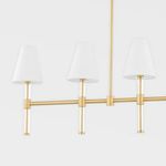 Side view of three connected chandelier arms with white shades and brushed gold metal structure.