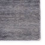 Close-up of rug surface showing dense handwoven PET yarn with subtle distressed pattern and soft pile