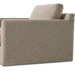 Angled back view showing cushioned backrest and armrest covered in sand-colored upholstery