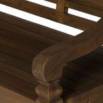 Close crop on curved armrest detail showcasing smooth finish and natural wood color variations