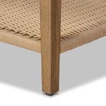 Close-up of straight oak leg and bottom of woven paper cord shelf