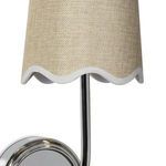 Close-up showing textured woven fabric and scalloped linen trim on amber-toned lampshade