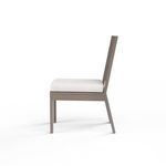Side profile of Laguna armless chair showing angled backrest and cushion thickness