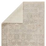 Backside folded over revealing solid cream backing of the Michon Oriental gray and cream rug