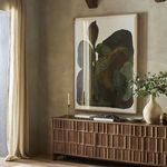 Framed artwork styled on wall with natural light, beige curtains, and decorative green foliage
