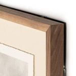 Close-up showing walnut frame bevel and rough edges of mounting paper