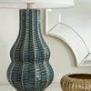 Quinn Lamp in room setting beside gold decorative vase and mirror, side angle view