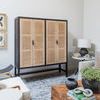 Living room corner featuring rattan cabinet and wood furniture with Atlas Marble Chain décor