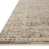 Close-up angled view highlighting the rug’s low pile texture and detailed floral border with fringed edge.
