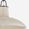 Close-up on ceramic shade texture and bulb under muted cream glaze