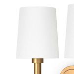 Close-up of white linen shade showing fabric texture and brass holder