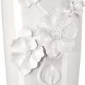 Close-up showing intricately sculpted flower petals and detailed leaf veins on vase