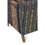 Focus on vertical tapered wooden rear leg with visible grain against patterned upholstery