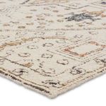 Edge detail with corner folded back to show rug's tightly stitched binding and backing texture