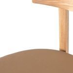 Partial seat view focusing on leather upholstery grain and stitching