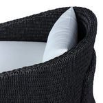 Zoom on thick wicker armrest and curved back with woven detail