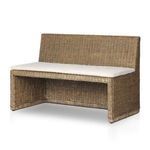 Close-up focusing on bench's side fabric cushion section over rattan frame