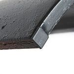 Close-up of black rubber foot pad on the metal leg base
