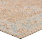 Close-up angle showing the rug’s low pile texture and detailed beige, blue, and brown patterns