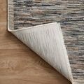Rug corner flipped up revealing woven backing with vertical stripe texture
