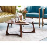 Godenza table side view surrounded by mid-century modern furniture including teal chairs and green leather sofa