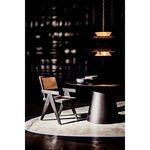 Table shown with wood woven chair and soft rounded pendant light casting distinct shadows
