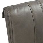 Close-up of rolled edge detail and stitching on leather backrest corner