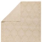 Top view of Milada rug folded at corner, revealing woven backside and fringed edges