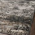 Close-up view of Estelle Charcoal Granite rug texture and color variation on wood floor