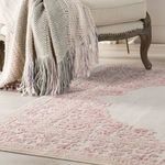 Close-up of chair with dangle gray and purple throw over Malo Medallion rug’s floral border