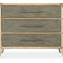 Front view highlighting three horizontally aligned drawers with textured metal bar pulls on Retreat Pole Rattan chest.