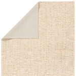 Back corner fold showing solid cream rug backing and wool pile front texture