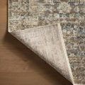 Backside view of Heritage Spa Earth rug corner flipped to reveal the woven fabric backing on wooden floor