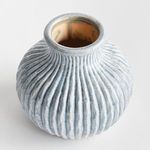 Top-down view shows round opening with beige-tan interior and blue ribbed exterior of Thessaly vase