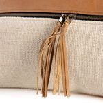 Close-up of leather tassels showing cut strips and zipper attachment
