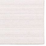 Detailed view of edge and diamond trellis pattern showing subtle distressed grays on white background