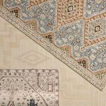Partial overlap showing the ivory Dahir rug with a contrasting blue and rust patterned rug beneath